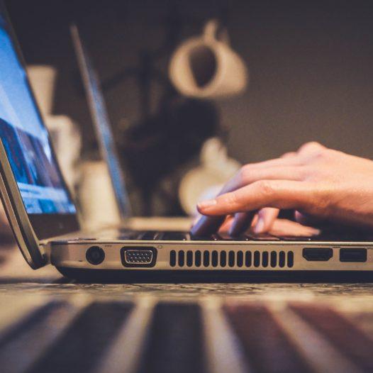 photo of person's hands typing on laptop computer